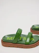 Sandalias de cuero vacuno color marrón con acabado brillante, diseño de dos tiras anchas acolchadas y plataforma baja.