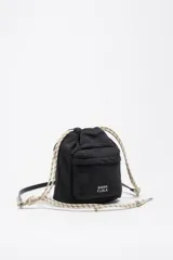 Bolso bucket mini Bimba y Lola de color negro, con cierre de cordón ajustable estilo marinero en tonos beige y negro, bolsillo frontal con solapa y logo estampado de la marca. Cuenta con asa larga ajustable.