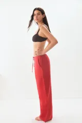 Pantalon de corte recto y holgado, confeccionado en una mezcla de lino y algodón. Presenta una cintura elástica con cordón ajustable y bolsillos laterales.