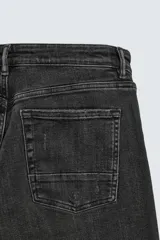 Jeans skinny fit de corte ajustado y tiro medio en color negro con efecto lavado y detalles desgastados. Confeccionados en tejido elástico con mezcla de algodón, presentan diseño clásico de cinco bolsillos y cierre frontal con cremallera y botón.