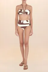 Top de bikini bandeau color marrón con estampado abstracto en blanco, con tiras finas al cuello y varilla en forma de U al centro.