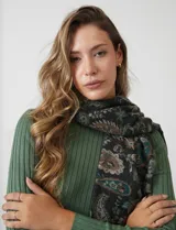 Bufandón de tejido soft, marca Adrienne Vittadini, con estampado de arabescos en tonos verde, beige y negro. Presenta terminación con flecos.