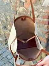 Bolso tote de cuero color natural con detalles en marrón.