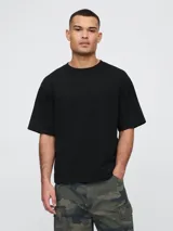 Remera color beige de corte holgado y mangas cortas.