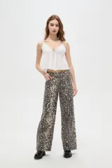 Pantalon de jean de corte ancho y tiro alto, con estampado tipo animal print desgastado en tonos gris y blanco.