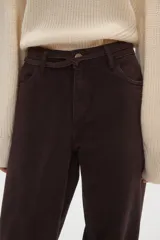 Pantalon de jean de corte ancho y tiro medio, en color natural, con cierre frontal y bolsillos laterales.