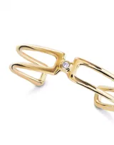 Pulsera doble abierta de metal dorado con un topacio blanco en cada extremo.
