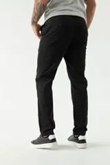 Pantalón chino de corte skinny, color azul marino, con bolsillos laterales y traseros. Se ajusta a la cintura con cinturón.