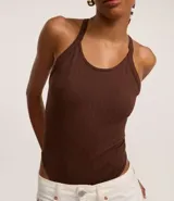 Body marrón oscuro de tejido acanalado, con escote redondo y breteles finos que se cruzan en la espalda.