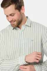 Camisa de lino de manga larga con diseño de rayas verticales en tonos verde y blanco, cuello camisero, cierre frontal de botones y bordado sutil en el pecho.