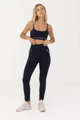 Calza larga de lycra negra con cintura alta y vivos blancos en la parte posterior.