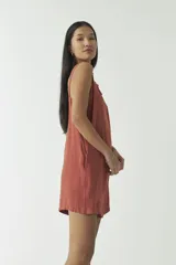 Mono corto estilo jardinero color ladrillo, con tirantes ajustables con hebillas metálicas.