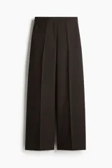 Pantalón de vestir de tiro alto y piernas amplias, color marrón oscuro, con pliegues frontales y bolsillos laterales.