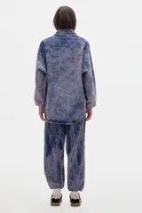 Camisa de jean oversized con lavado washed. Escote en V bajo con cuello camisero, mangas abullonadas.