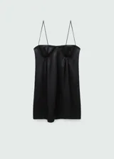 Vestido corto negro con escote corsetero y tirantes finos. Presenta un diseño entallado y cierre lateral invisible.