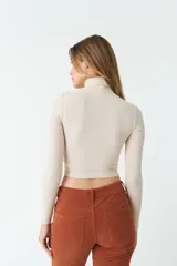 Polera negra de cuello alto y manga larga, de corte ajustado.