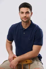 Remera polo piqué azul marino de manga corta, con cuello camisero, cierre frontal con botones y pequeño bordado al tono en el pecho.