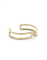Pulsera doble abierta de metal dorado con un topacio blanco en cada extremo.