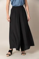 Pantalón ancho de seda color negro, con cintura elastizada y caída fluida.