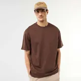 Camiseta marrón de corte oversize y diseño liso, con cuello redondo y mangas cortas.