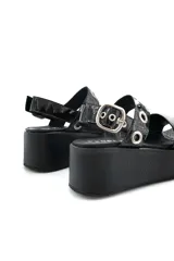 Sandalia negra de cuero con plataforma y ajuste con hebilla.