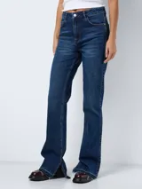 Jean de tiro alto con corte bootcut, confeccionado en denim azul oscuro. Presenta diseño de cinco bolsillos, cierre frontal con botón y cremallera, y terminación con tajos laterales en el ruedo.
