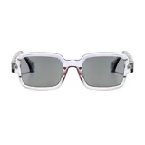 Lentes de sol con armazón rectangular oversize transparente y acabado translúcido en tonos rosados y grises. Lentes oscuros con protección UV 400.