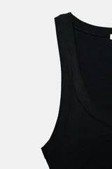 Musculosa de punto rib color blanco, con escote redondo y diseño ajustado.
