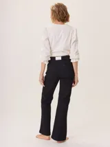 Pantalón negro de algodón, con corte recto, costura central en la pierna, bolsillos con pespuntes irregulares y pasacintos.