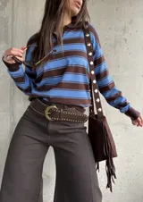 Sweater liviano de punto con diseño polo, cuello y puños en color marrón chocolate, y rayas horizontales alternadas entre azul y marrón. Cuenta con mangas largas y botones en el escote.