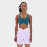 Top deportivo Reebok de tirantes anchos y escote redondo, color verde azulado oscuro. Presenta un pequeño logo de Reebok en el centro inferior del busto.