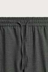 Pantalón regular fit color negro de tejido con viscosa, con cintura elástica ajustable con cordón, bolsillos frontales y traseros.