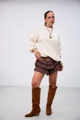 Sweater de punto color beige, con cuello redondo y mangas largas abullonadas, de corte holgado.