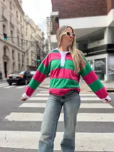 Sweater a rayas horizontales rosas y verdes, con cuello polo blanco y puños blancos.