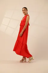 Vestido largo rojo con escote en V, breteles con lazos y volados en el busto y en el ruedo.