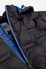 Campera puffer negra de nylon con capucha desmontable, cuello medio y bolsillos con cierre.