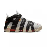 Championes Nike Air More Uptempo 96 de color blanco, negro y gris, con detalles en naranja y rojo. Presentan el característico diseño con las letras "AIR" sobredimensionadas en los laterales, suela de goma con amortiguación visible y un estilo urbano robusto.