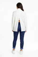 Pantalón de corte ajustado confeccionado en tejido jacquard con estampado sutil en tonos azules. Presenta bolsillos delanteros funcionales, cierre frontal y un diseño que estiliza la figura.