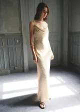 Vestido largo color crudo con sutil textura en relieve, escote drapeado y tirantes finos.