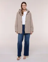 Campera impermeable Gallery de color beige, con capucha plegable, cierre frontal oculto con botones a presión, bolsillos delanteros y cordón de ajuste en la cintura.