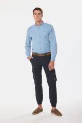 Pantalón cargo azul marino con bolsillos laterales con solapa y cinturón de cuero marrón.