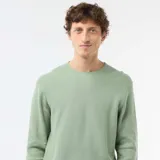 Sweater de punto con textura de nido de abeja, color verde, con cuello redondo y mangas largas.