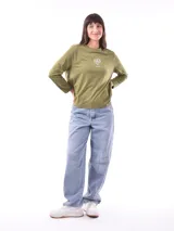 Remera de manga larga color beige, con cuello redondo y estampado frontal que dice "Magic is something you make" en color lila.