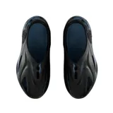 Sandalias tipo zueco cerradas, color negro, con diseño futurista y texturizado, y orificios de ventilación laterales. La suela es gruesa y ergonómica.