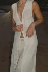 Chaleco largo de tejido de punto calado con diseño geométrico, escote en V profundo y cierre frontal con ganchito.