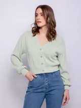 Saquito color verde agua, corto, de manga larga y escote en v. Cuenta con cuatro botones brillantes. Su tela es de textura diferenciada con un leve brillo.