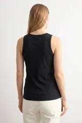 Top sin mangas de tejido canalé, con cuello redondo y ajuste al cuerpo.