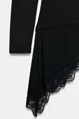Camiseta de manga larga confeccionada en viscosa, con cuello barco y ajuste slim fit. Presenta un diseño con drapeado lateral y un bajo asimétrico decorado con una aplicación de encaje.