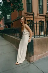 Vestido largo de georgette con escote en pico, tirantes finos cruzados en la espalda y detalle de volantes aplicados en el pecho.