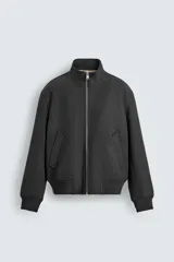 Cazadora bomber de corte regular con forro interior de tejido efecto pelo. Presenta cuello subido, cierre frontal con cremallera metálica, bolsillos laterales de vivo y acabados en rib en puños y cintura.